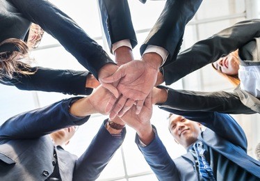 asian business employees hug hand together. employees teamwork is importance for work.cooperating together on various tasks reduces workloads for all employees