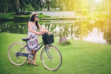 asian woman  take bicycle beside the marsh.