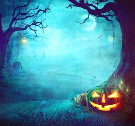 halloween pumpkin in dark forest. halloween background. halloween pumpkin with graveyard