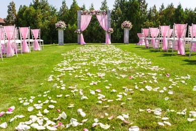 tender pink and white wedding ceremony decorations on the lawn
