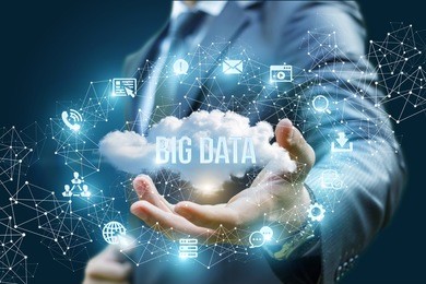 businessman showing a cloud with the words big data on blue background.