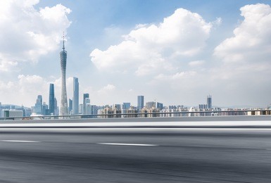 blurred empty asphalt road and cityscape of guangzhou in blue sky