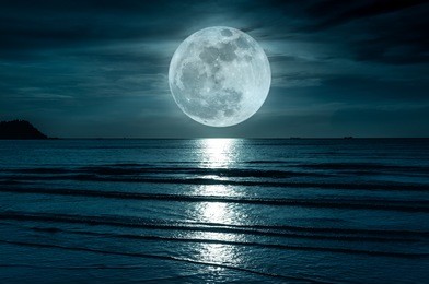 super moon. colorful sky with cloud and bright full moon over seascape in the evening. serenity nature background, outdoor at nighttime. the moon taken with my own camera.