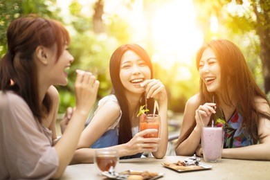 group of young woman laughing in restaurant