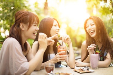 group of young woman laughing in restaurant