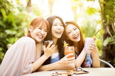 group of young woman laughing in restaurant