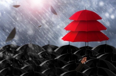 insurance agent holding red umbrella three layers to protect the life, health, savings, investment and accident, insurance concept.