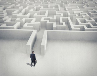 business challenge. a businessman navigating through a maze. top view