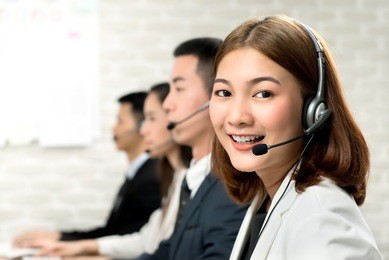 smiling beautiful young asian woman telemarketing customer service agent working in call center office with friendly and helpful attitude