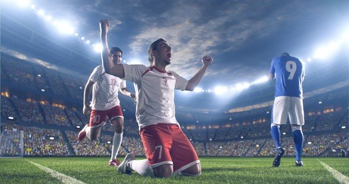 soccer players celebrate a victory during a soccer game on a professional outdoor soccer stadium. they wear unbranded soccer uniform. stadium and crowd are made in 3d.