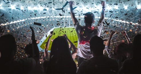 group of fans are cheering for their team victory