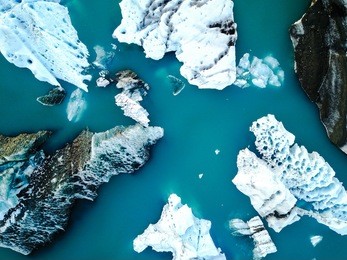 aerial view of amazing glacier patterns and shapes in jokulsarlon lake, iceland. glacial lagoon with icebergs floating. climate change, global warming, melting glacier.