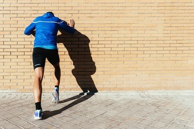 handsome man stretching in the city. fitness, workout, sport, lifestyle concept.