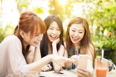 group of friends having fun and looking at smart phone
