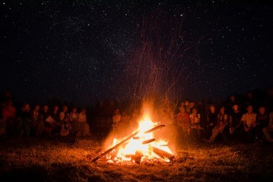 beautiful scenery of night vision. a bonfire around people, the concept of recreation