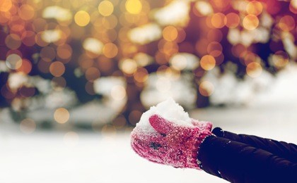 winter holidays, christmas and people concept - close up of woman holding snow outdoors
