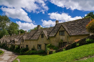rows of traditional cottages in the small historic town of bibury in england.