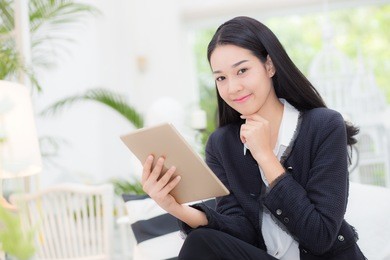 young businesswoman asian sitting at table looking tablet, business concept.