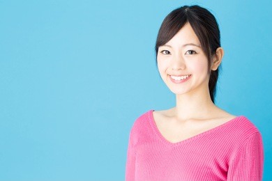 portrait of young asian woman isolated on blue background
