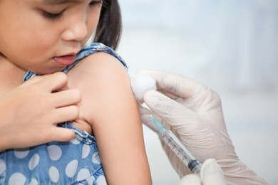 doctor injecting vaccination in arm of asian little child girl,healthy and medical concept