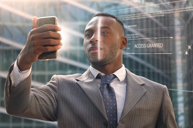 a businessman as bank and telephone bank protection has facial recognition, thanks to increased reality and futuristic technology. concept of: cyber security, business, technology and future