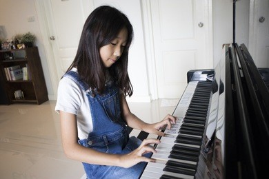 girl playing a piano