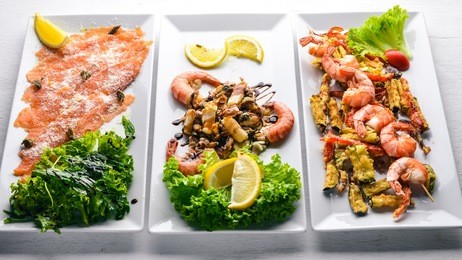 assorted seafood, salmon, octopus, squid, mussels, shrimp. on a wooden background. top view. free space.