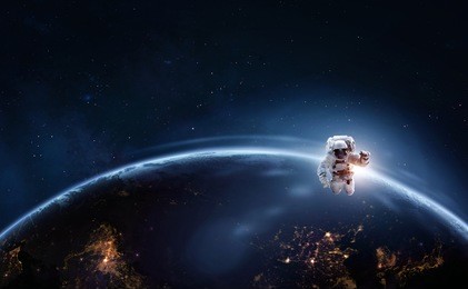 astronaut in outer space over of the planet earth at the night hemisphere. science theme. astronomy concept. elements of this image furnished by nasa.