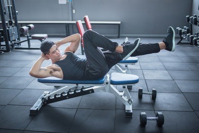 young adult man  working out in gym 