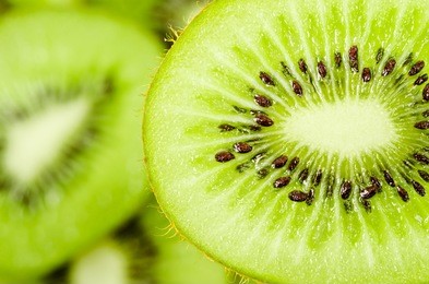 slices of kiwi fruit on kiwi background.