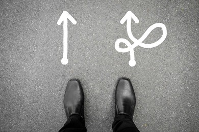 black shoes standing at the crossroad and has to make decision which way to go for his success - hard way or easy way