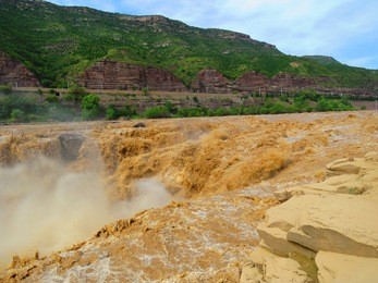  hukou ( tea kettle spout) waterfall in china , the world's largest yellow waterfall                              
