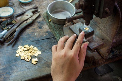 goldsmith makes gold necklace and jewelry. crafting part of gold necklace