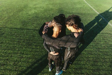 five a side football team gathering before match. young soccer team standing in a huddle.