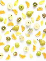 vertical composition of fruits on a white background. food background. collage of food. top view. pattern from pears, green apples, orange slices, kiwi and yellow petals of a tulip. 