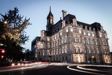 the historical montreal city hall building, a popular landmark in the old montreal district seen here at dusk on a summer night. canada