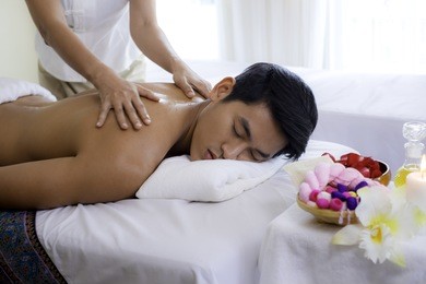 young man during oil massage at spa