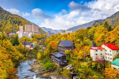 jozankei, hokkaido, japan inns and river skyline during the autumn season.