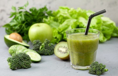 green smoothies in glassful with fresh vegetables and herbs: broccoli, avocado, lime, celery, apple, kiwi, parsley. detox smoothies