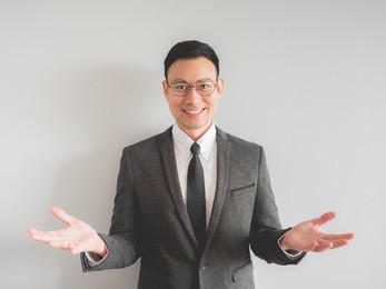 happy asian boss manager business man wears black suit in relax pose.