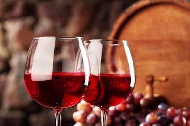 red wine.closeup two glasses of red wine, grapes and barrel.selective focus.
