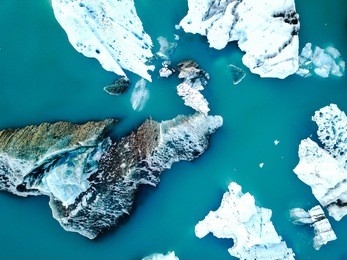 aerial view of amazing glacier patterns and shapes in jokulsarlon lake, iceland. glacial lagoon with icebergs floating. climate change, global warming, melting glacier.