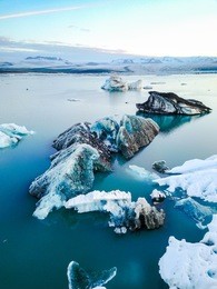 aerial view of amazing glacier patterns and shapes in jokulsarlon lake, iceland. glacial lagoon with icebergs floating. climate change, global warming, melting glacier.