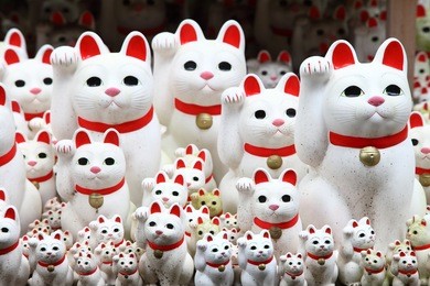 tons of small dolls "the beckoning cat" known as maneki neko at gotokuji in tokyo, japan.