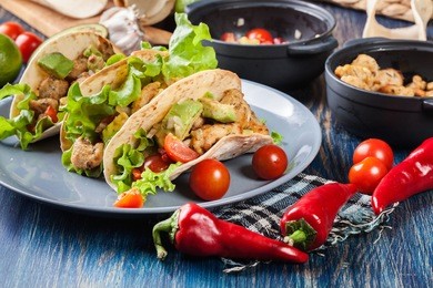 authentic mexican tacos with chicken and salsa with avocado, tomatoes and chillies. mexican cuisine.
