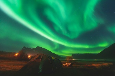 beautiful picture of massive multicoloured green vibrant aurora borealis, aurora polaris, also know as northern lights in the night sky over norway, scandinavia
