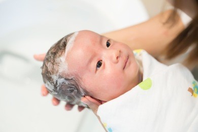 asian newborn baby boy taking a shower and wash hair by mother in the bathroom, five week old, child kid concept