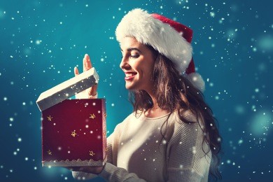 happy young woman opening a christmas present box