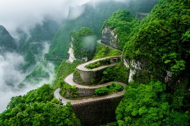 the winding road of tianmen mountain national park (zhangjiajie) in clouds mist, hunan province, china