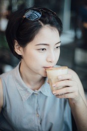asian woman drinking coffee cafe in vintage color tone